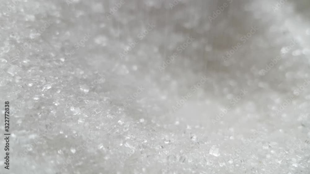 Granulated sugar in tea spoonful, close up Granulated sugar in tea spoonful, close up
