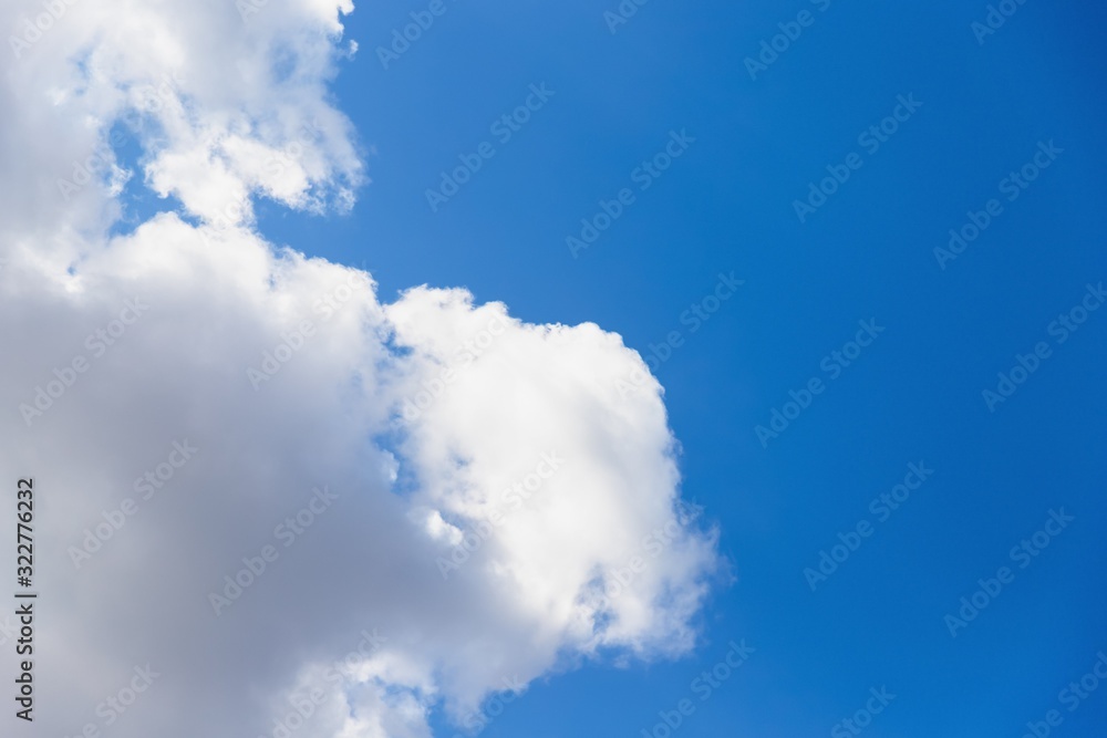 Beautiful white big soft fluffy cloud on a clear blue sky background Beautiful white big soft fluffy cloud on a clear blue sky background