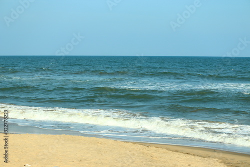 landscape for big water wave and blue sea against blue clear sky with sand beach backgrounds, beach and sky images, © Dinesh