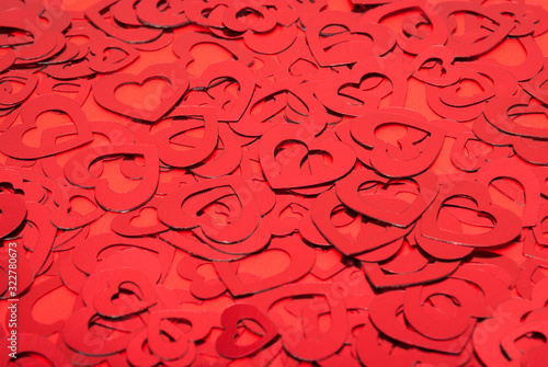 Pile of different sized red hearts in a textured Valentine's Day background