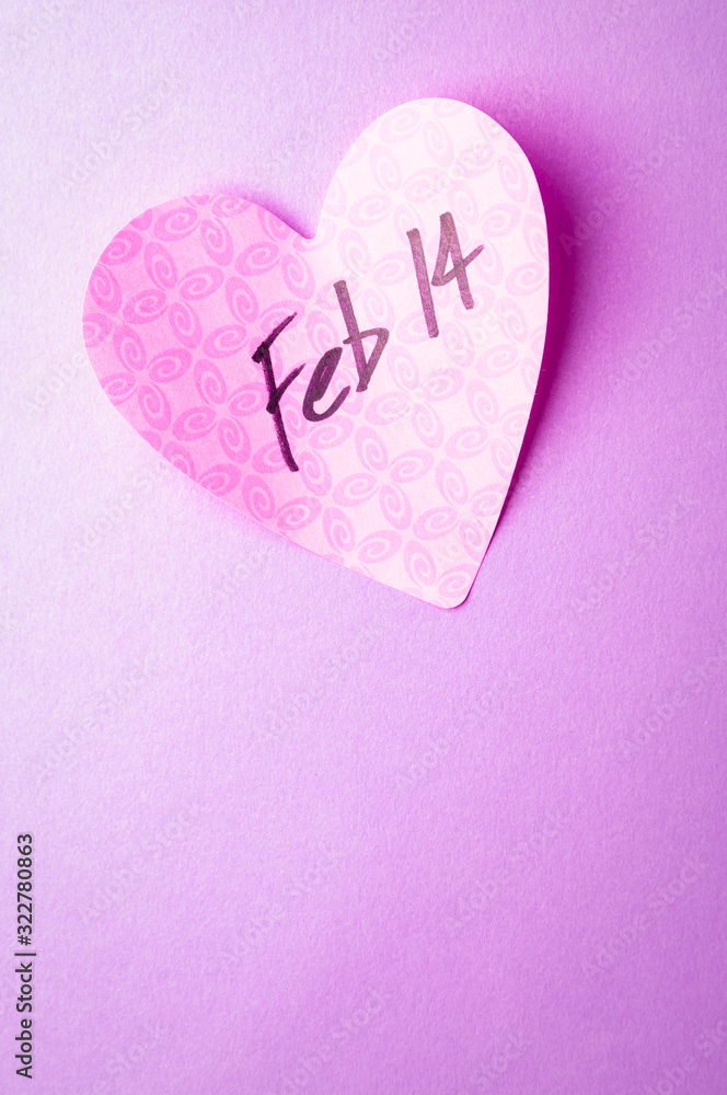Handwritten reminder of Feb 14th Valentine's Day on pink heart with simple lavender copy space