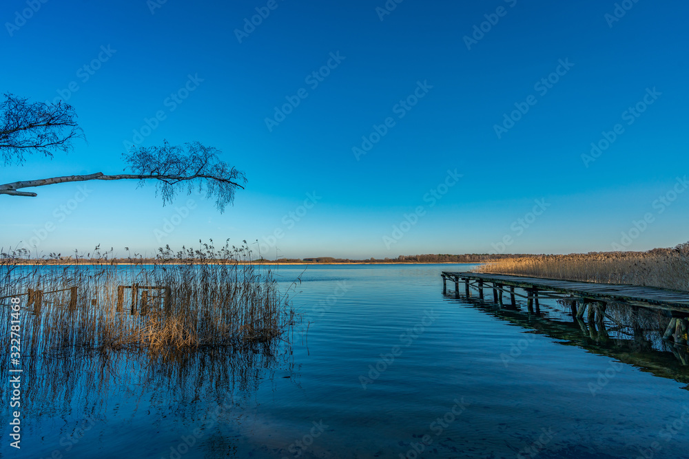 Old wooden landing stage at a tranquil lake