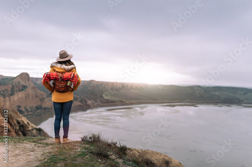young girl traveling the world with her backpack hiking