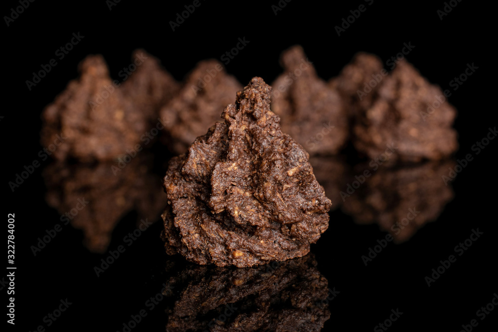 Lot of whole homemade brown coconut cocoa biscuit isolated on black glass Lot of whole homemade brown coconut cocoa biscuit isolated on black glass