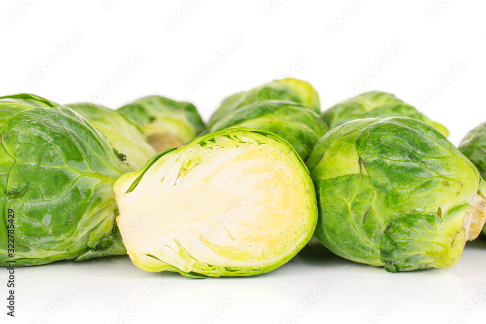 Lot of whole one half of fresh green brussels sprout isolated on white background Lot of whole one half of fresh green brussels sprout isolated on white background