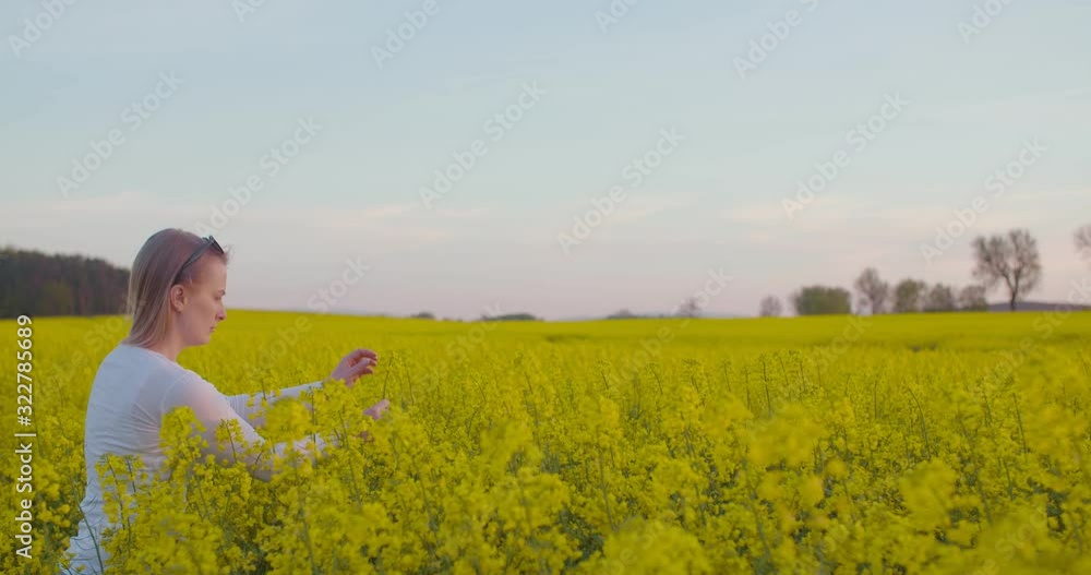 Female Farmer Examining Oilseed Rape Field Female Farmer Examining Oilseed Rape Field