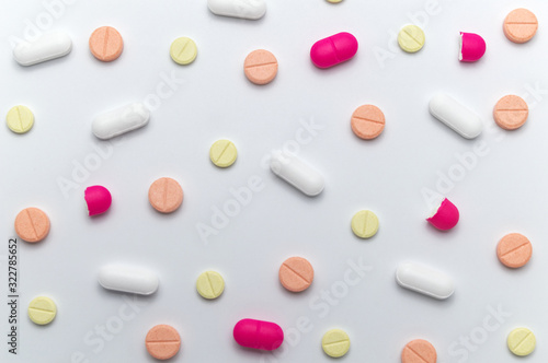 Different colorful drugs or medicine pills tablet supplements for the treatment and health care on a white background.