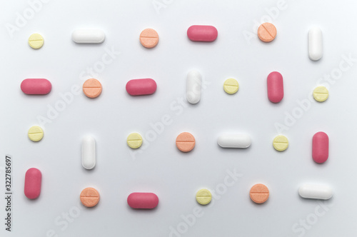Different colorful drugs or medicine pills tablet supplements for the treatment and health care on a white background.