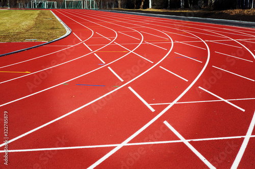 Red running tracks on the sporting venue center. Striped tracks for competing sports.
