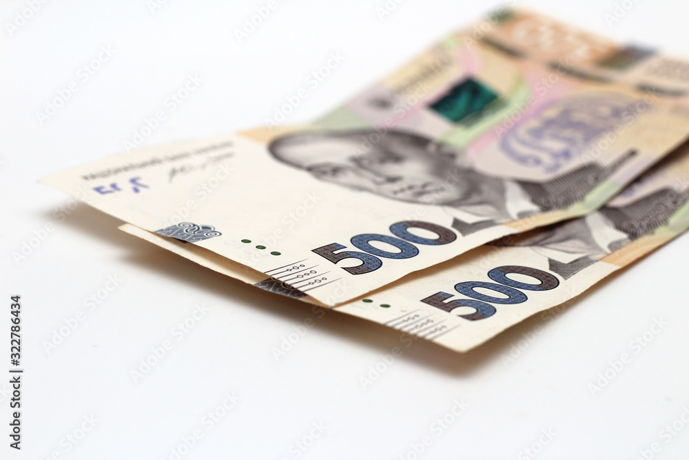 Two new banknotes in denominations of 500 Ukrainian hryvnias isolated on a white background with shadow. European money exchange. Ukraine currency Two new banknotes in denominations of 500 Ukrainian hryvnias isolated on a white background with shadow. European money exchange. Ukraine currency