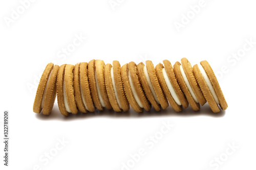 Stack of sandwich cookies milk flavoured cream isolated on white background.