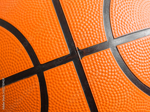 Orange basketball ball close up. Fragment, black stripes, texture. Sport geometric background © antonbelo