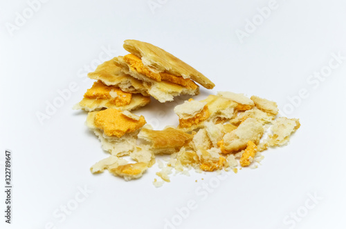 Biscuit and crumbs of sandwich cracker Cheese flavoured ,Cream and butter. Crunchy delicious sweet meal and useful cookies. On white background. Selective focus.