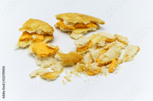 Biscuit and crumbs of sandwich cracker Cheese flavoured ,Cream and butter. Crunchy delicious sweet meal and useful cookies. On white background. Selective focus.