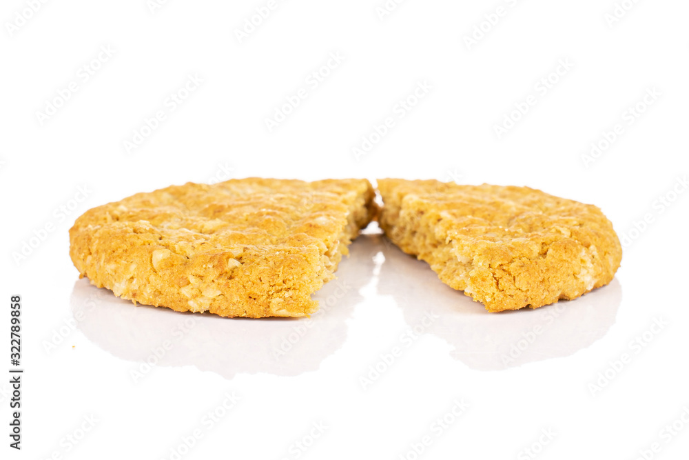 Group of two halves of sweet golden oat cookie isolated on white background Group of two halves of sweet golden oat cookie isolated on white background