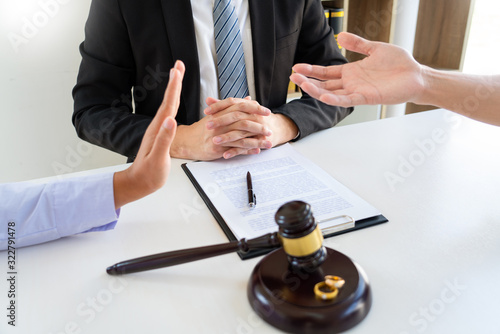 Judge gavel deciding on agreement prepared marriage divorce and Angry couple arguing telling their problems settlement, legal separation concept.