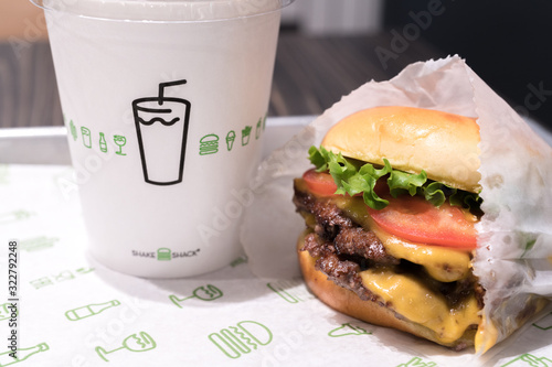 Tokyo Japan - March 27, 2019: Shake Shack Hamburger in Tokyo. Double cheeseburger with tomato lettuce and onion, Cheese Fries and Milkshake.