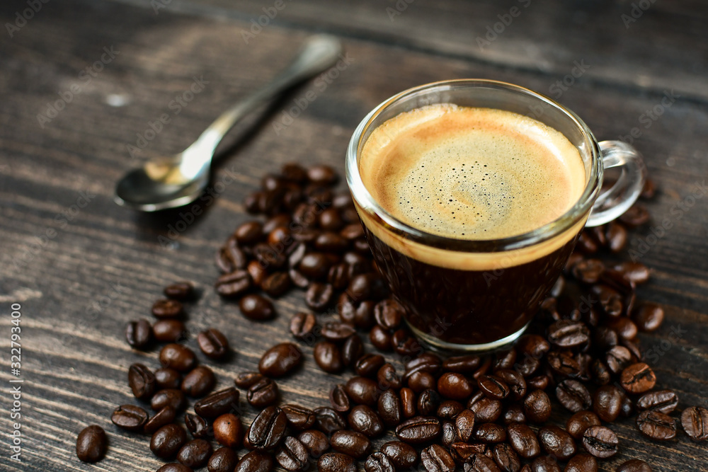 Coffee cup espresso and beans on a wooden background. breakfast concept, italian coffee Coffee cup espresso and beans on a wooden background. breakfast concept, italian coffee