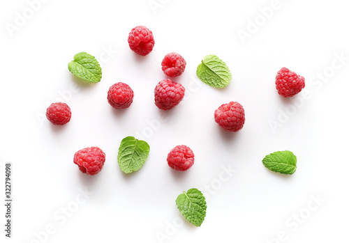 Ripe rasberries and mint isolated on white background. Top view