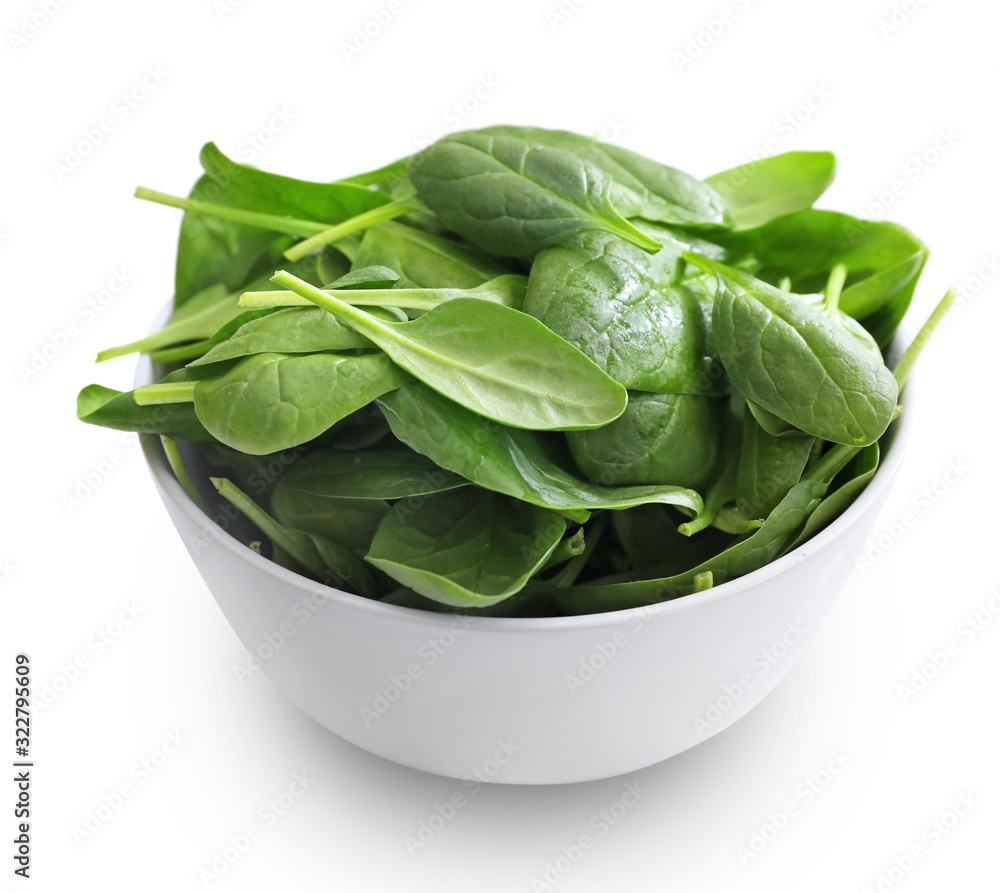 Spinach leaves in bowl isolated on white Spinach leaves in bowl isolated on white