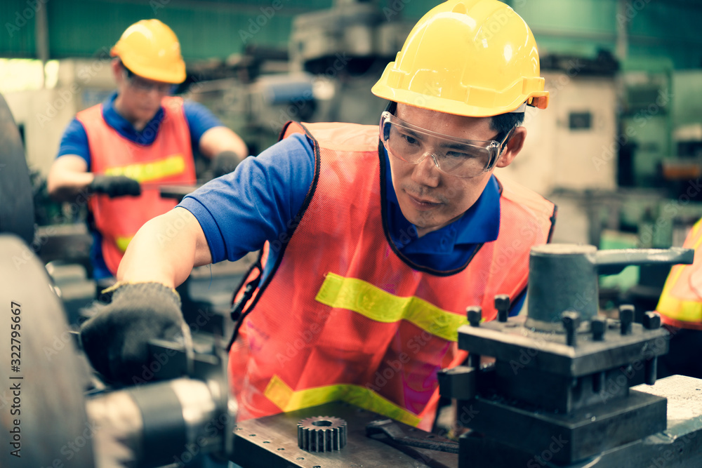 The industrial factory inspector wearing safety helmet and goggle watching on measurement tools on factory machine equipments to keep tracking value of iron stress, Concept annual safety auditing. The industrial factory inspector wearing safety helmet and goggle watching on measurement tools on factory machine equipments to keep tracking value of iron stress, Concept annual safety auditing.