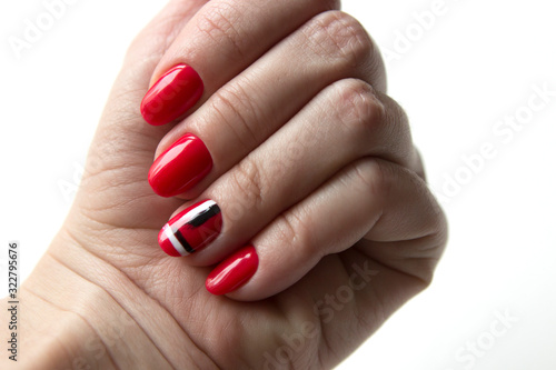 fresh modern manicure, red nails, one of the nails has an abstract drawing.