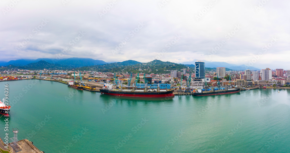 panorama of the port of Batumi and ships at the mooring wall. Bulk cargo ship under port crane, Batumi seaport, Georgia