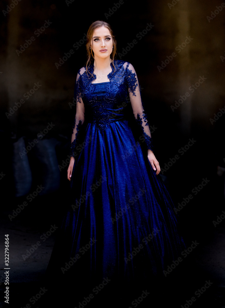 Beautiful teen girl in beautiful ultramarine prom dress prom dress.