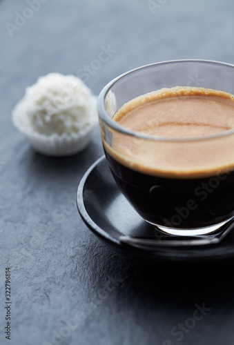 Coffee in glass cup on dark stone background. Close up. 