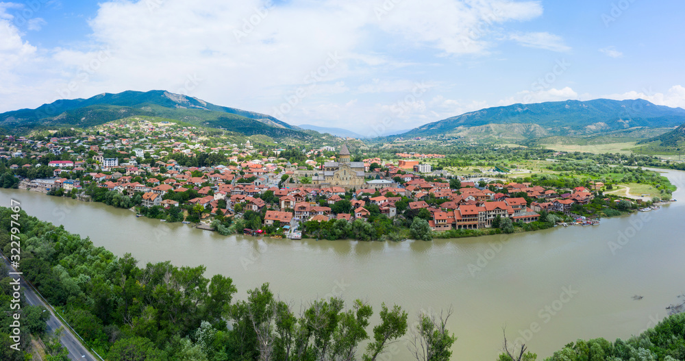 Panoramic view of Mtskheta, The Old Town Lies At The Confluence Of The Rivers Mtkvari And Aragvi. Svetitskhoveli Cathedral, Ancient Georgian Orthodox Church, Unesco Heritage In The Center. - obrazy, fototapety, plakaty 