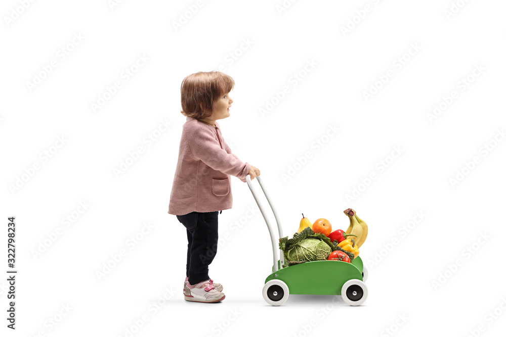 Little girl pushing a toy cart with fruits and vegetables Little girl pushing a toy cart with fruits and vegetables