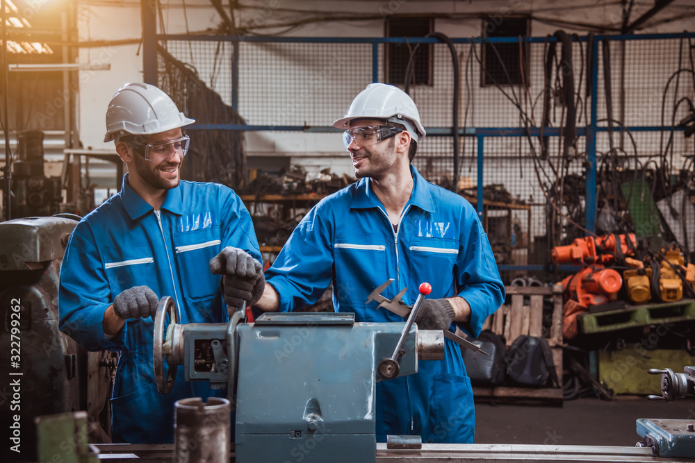The Industry engineering wearing safety uniform used Vernier caliper to measure the object control operating machine working in industry factory The Industry engineering wearing safety uniform used Vernier caliper to measure the object control operating machine working in industry factory