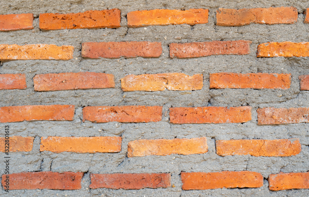 Obraz premium A orange brick wall background, wallpaper