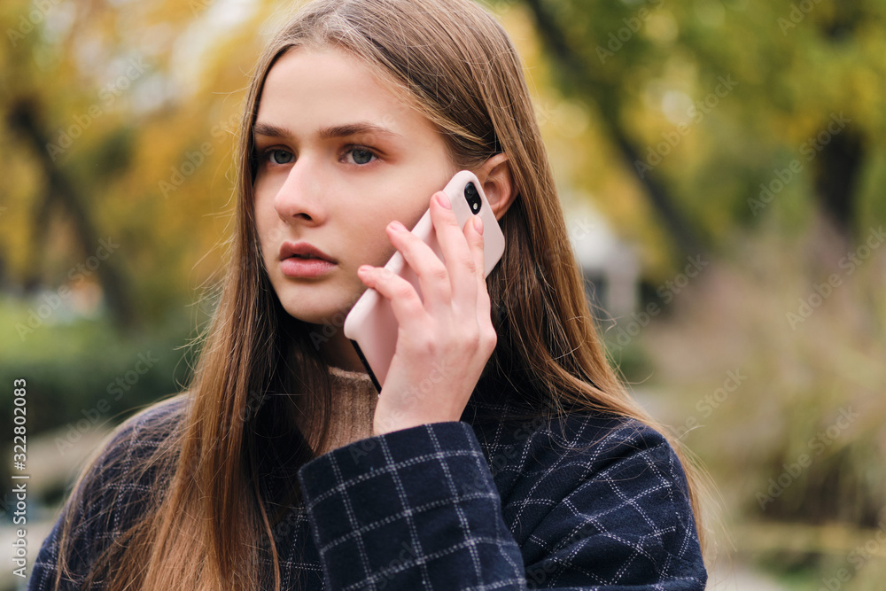 Portrait of serious girl talking on cellphone outdoor Portrait of serious girl talking on cellphone outdoor