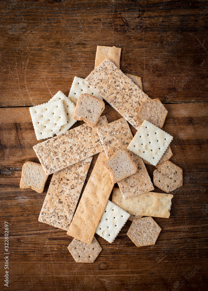 Fototapeta premium Abstract assortment of edible crackers in a a variety of shapes and textures as a flat lay