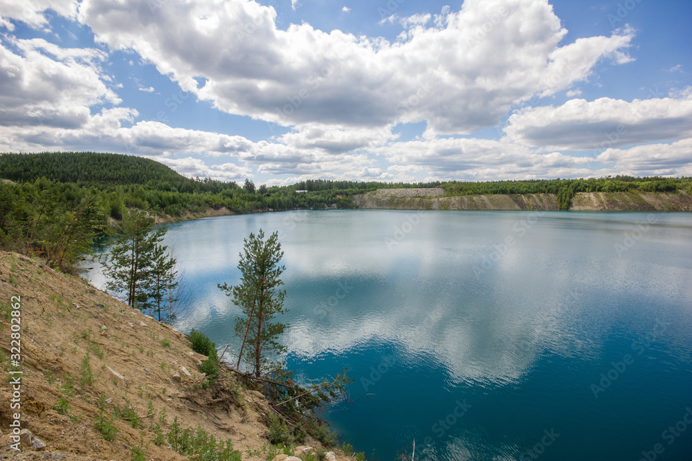 Flooded emerald quarry lake with blue water landscape