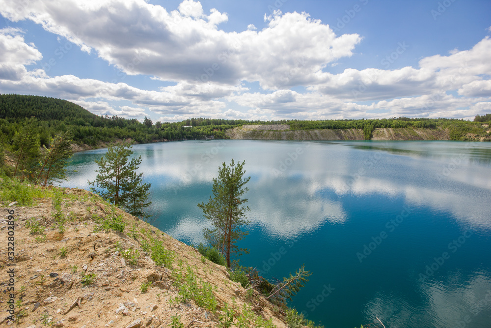 Flooded emerald quarry lake with blue water landscape