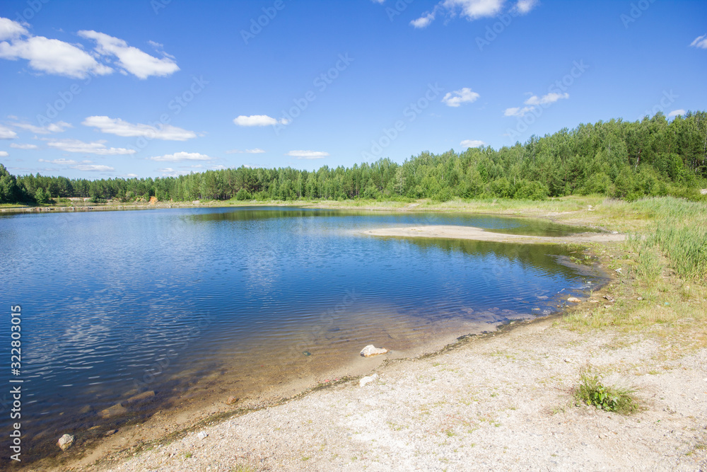 Flooded emerald quarry lake with blue water landscape