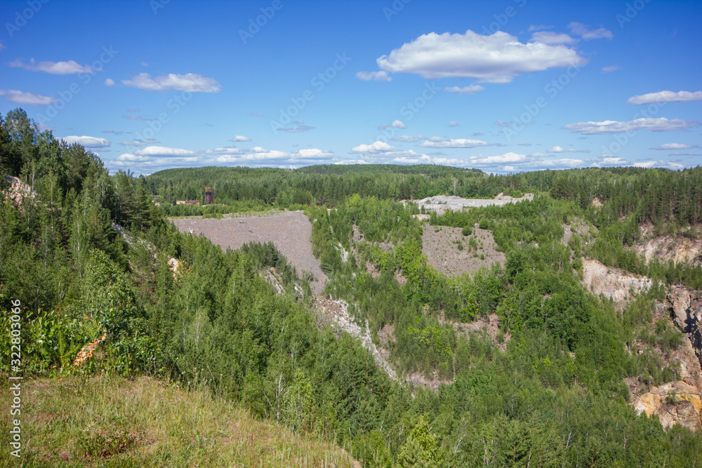 Old emerald ore quarry mining at summer day