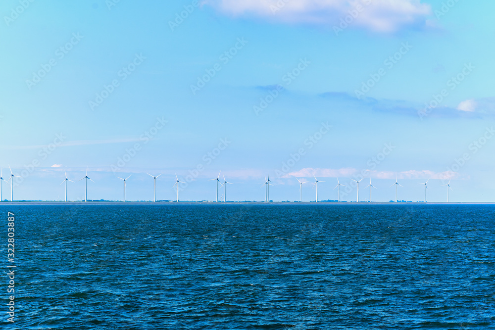 Wind turbine  in the background blue sky and sea