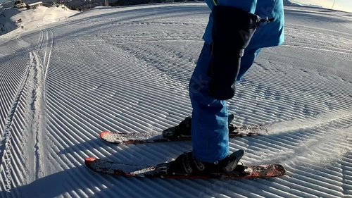 Little boy skiing. A 6 year old child enjoys a winter holiday in the Alpine resort. Stabilized footage. Slow motion.