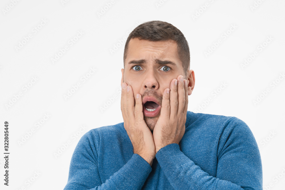 Close up of young handsome man with beard scared over isolated white background Close up of young handsome man with beard scared over isolated white background