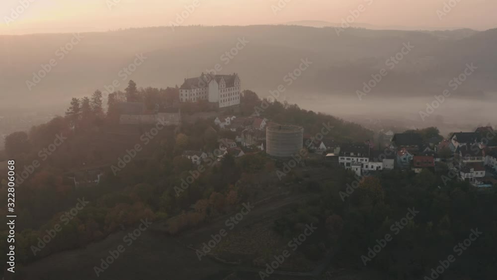 Aerial view of historic castle at foggy sunrise in Germany in 4k Aerial view of historic castle at foggy sunrise in Germany in 4k