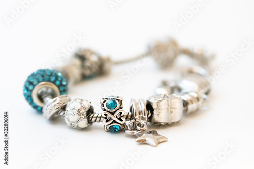 Obraz na płótnie Beautiful bracelet with charms isolated on white background
