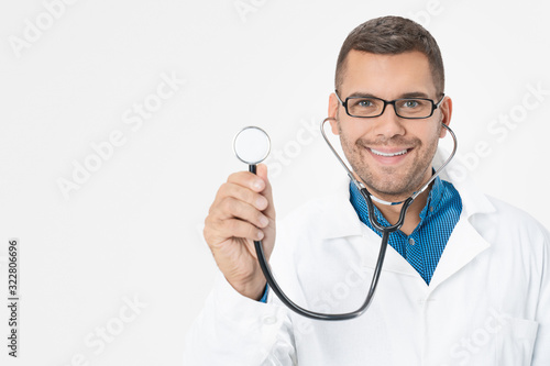 Young handsome male doctor using stethoscope over white background
