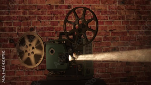 Wide shot of a finished film reel with the film flapping after finishing playing on a vintage projector.