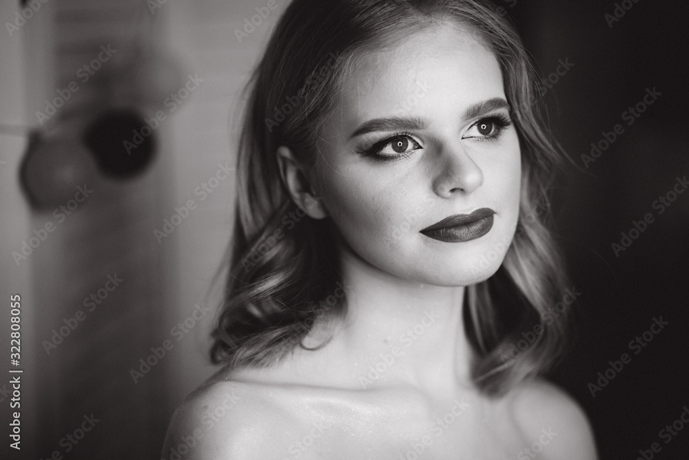 Naklejka premium Portrait of beautiful blond hair lady after makeup in beauty studio. Black and white photo. Ring lamp