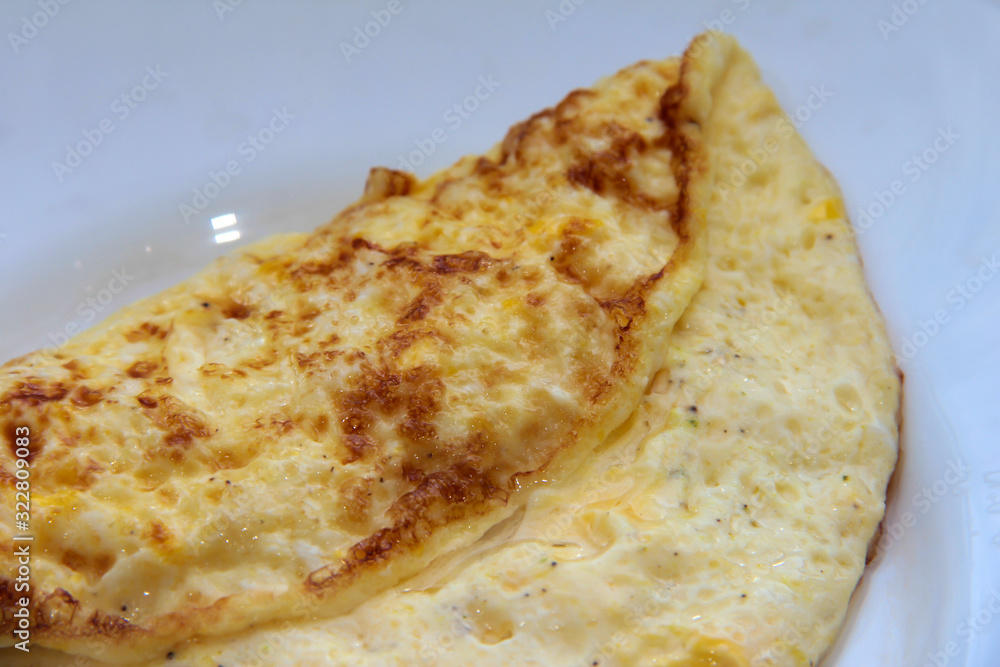Omelet on a white plate. Wholesome breakfast. Omelet on a white plate. Wholesome breakfast.