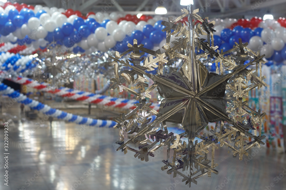 Brilliant decorative snowflake, preparation of a festive event in a huge room.