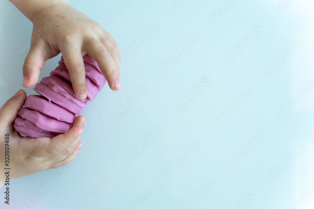 Mentent children's handles are made of pink mass for sculpting on a light surface. children's creativity Mentent children's handles are made of pink mass for sculpting on a light surface. children's creativity